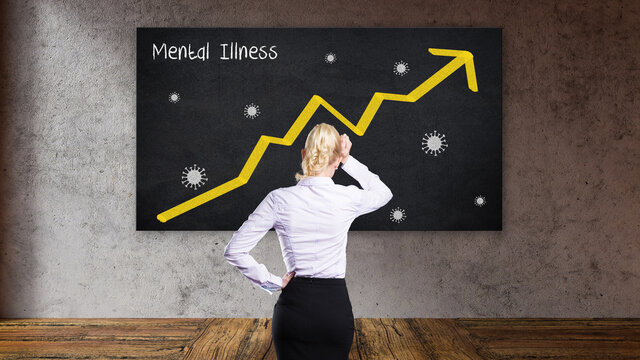 blonde buisinesswoman in front of a blackboard with a rising graph and the message MENTAL ILLNESS