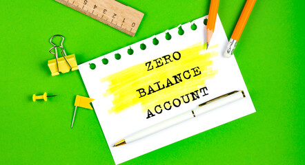 Text ZERO BALANCE ACCOUNT sign showing on the green background with office tools