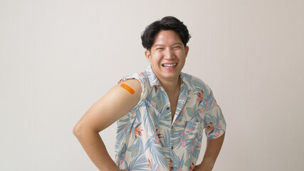 Adult mature attractive handsome asia hipster male after shot receive covid-19 anti virus vaccine...
