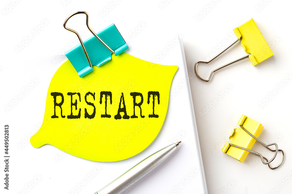 Poster sticker with restart text on notebooks on the white background
