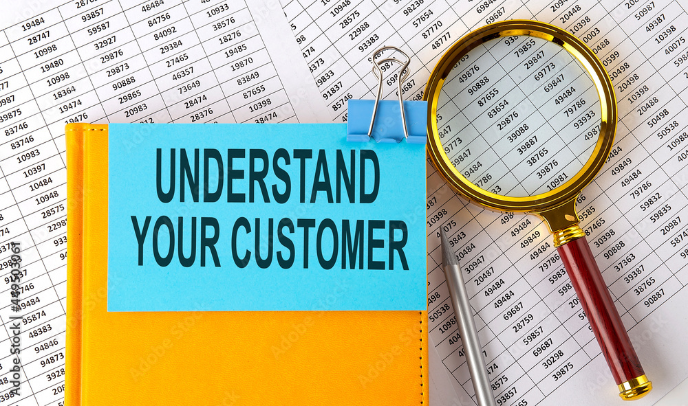 Aufkleber understand your customer text on sticker on notebook with magnifier and chart. business concept