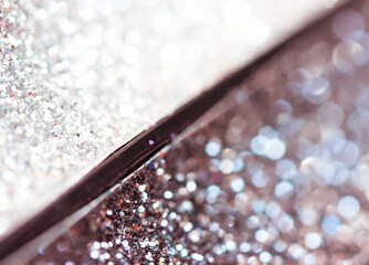 Silver grey sparkling glittering eye shadow palette up close. Makeup products.