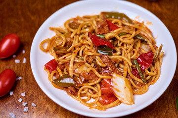 lagman with vegetables, meat in a white plate