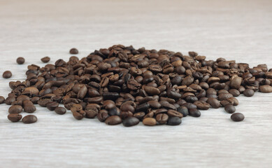 Coffee beans on a wooden background. Close-up. Selective focus.