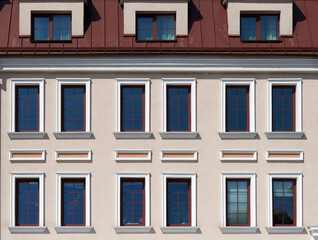 Fragment of the facade with an attic in a classic style