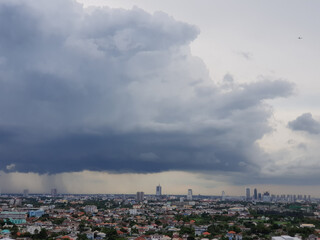 Rain clouds are falling far in the city.