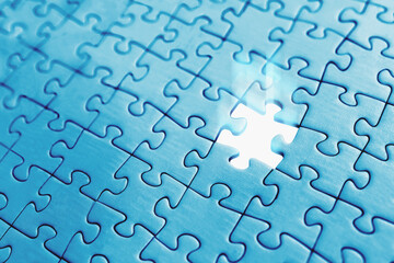 One missing piece jigsaw puzzle, with light glowing. Business and technology concepts