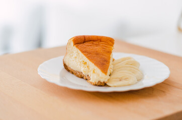 Close-up of cheesecake with banana on a white plate