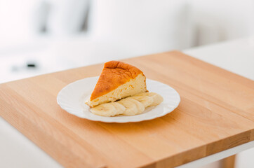 Close-up of cheesecake with banana on a white plate