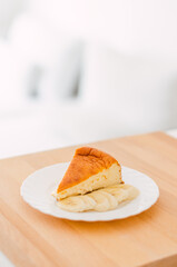 Close-up of cheesecake with banana on a white plate