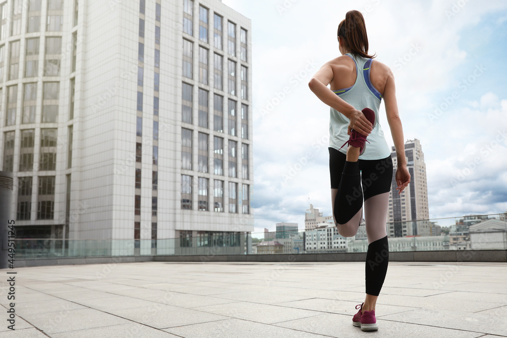 Canvas Prints Woman stretching before morning fitness outdoors, back view