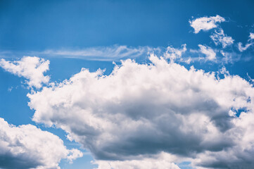 Blue sky background with clouds. Beautiful sky background on a sunny day.