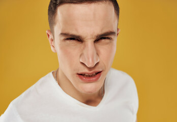 Obraz premium angry man in white t-shirt emotion close-up isolated background