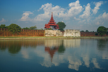 An ancient gate with a bastion with a reflection. Mandalay, Burma (Myanmar)