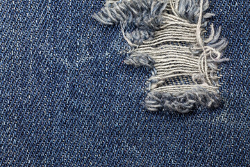 Fototapeta na wymiar Blue torn denim jeans texture