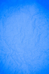 Crumpled blue paper background.