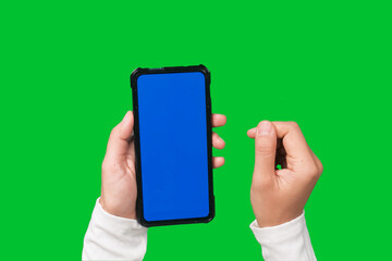 Woman hand holding smartphone with blue screen on chroma key green screen background.