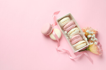 Concept of tasty dessert with macaroons on pink background