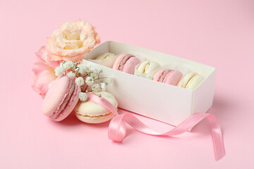 Concept of tasty dessert with macaroons on pink background