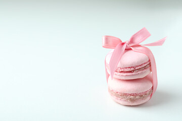 Concept of tasty dessert with macaroons on white background