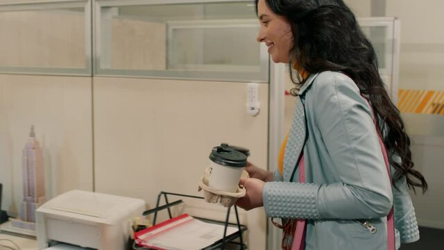 In a large office pretty lady manager take some takeaway coffee and bringing to her colleague charismatic guy