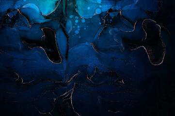 Abstract colorful background, wallpaper. Mixing gold foil paints. Modern art. Paint blue marble texture. Alcohol ink colors translucent. Fluid art and Liquid marble texture background.