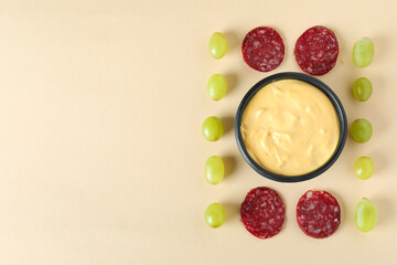 Concept of delicious food with fondue on beige background