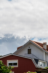 Fototapeta na wymiar side facades of single-family houses with water-laden clouds