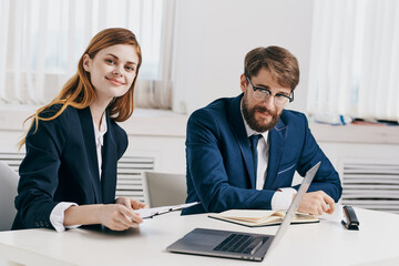 business man and woman work together in front of laptop office technology
