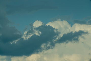 Blue sky background with stormy and white clouds.