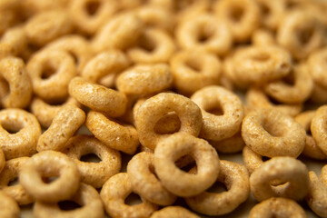 closeup cheerios oat cereal in large pile, background, delicious breakfast