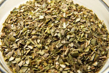 Oregano spice detail macro. Spilled oregano spice macro.