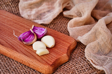 Cloves of garlic on a wooden board, rustic style, natural eco product