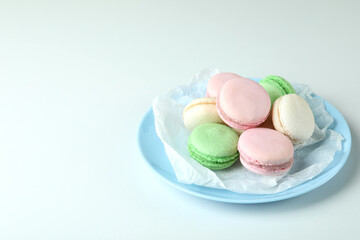 Concept of tasty dessert with macaroons on white background