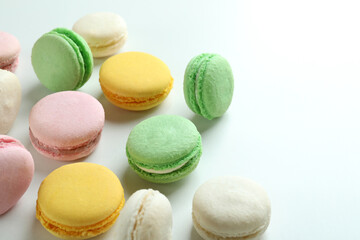 Concept of tasty dessert with macaroons on white background