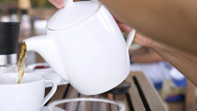 Coffee break at rest tea time after work from home. Making coffee and fresh milk or tea in empty cup on wood table drink with sweet snack dessert cake or cookies and hot drink. Drink cafe.