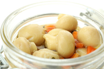 Glass jar of marinated mushrooms, close up