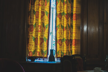 Iron retro jug on the windowsill in the room