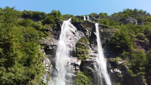 Water stream running from the beautiful Acquafraggia waterfall in Piuro, in the Bregaglia valley in Italy, before the ascent to the Maloja pass. It is a beautiful sunny summer day.