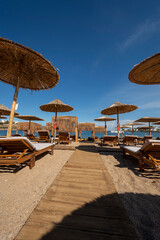 straw umbrellas on the beach at at Puta Zeza beach in Athens in Greece