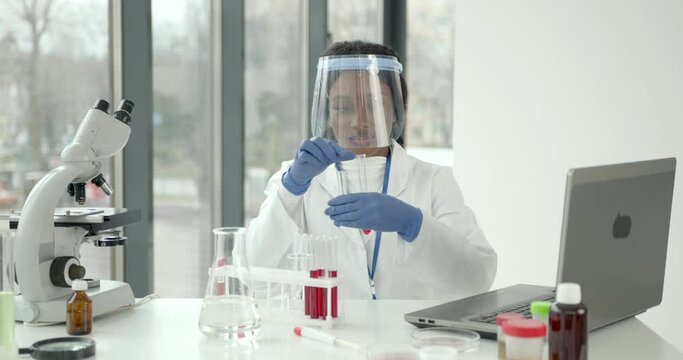 Female Scientist Working in The Laboratory Using a Microscope