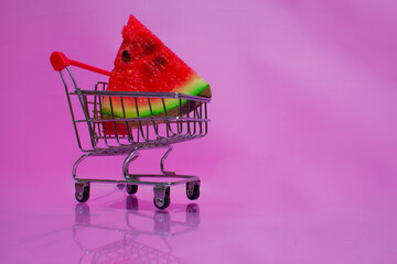 A triangular piece of watermelon in a supermarket cart.