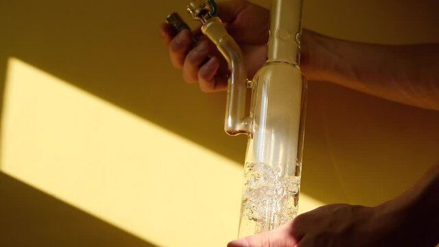 Close up smoking cannabis with water bong. Marijuana culture. 4k video. 