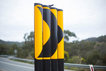 black arrow on yellow background, road sign in Adelaide, South Australian hills