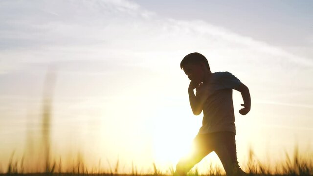 silhouette child kid boxer. boy a boxing with shadow exercising at sunset outdoor sun. kid dream. sport victory healthy lifestyle concept. child shadow boxing little champion boxer silhouette
