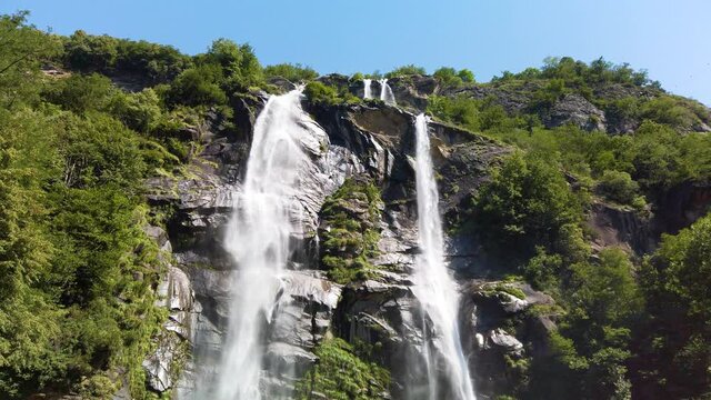Water stream running from the beautiful Acquafraggia waterfall in Piuro, in the Bregaglia valley in Italy, before the ascent to the Maloja pass. It is a beautiful sunny summer day.