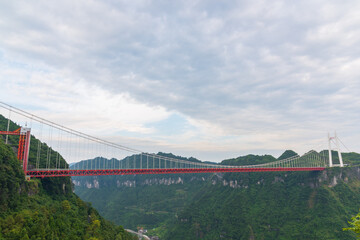 Fototapeta na wymiar The Aizhai Bridge is a suspension bridge on the G65 Baotou–Maoming Expressway near Jishou, Hunan, China. The bridge was built as part of an expressway from southwest China's Chongqing Municipality to 