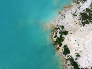 kaolin quarry with turquoise water and white clay.aerial view