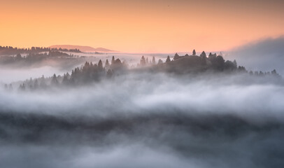 Colorful view of alpine valley covered with fog