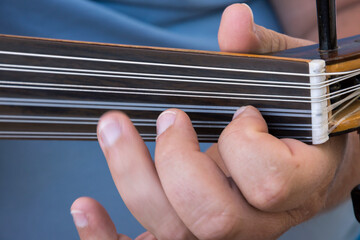 hands of a musician playing the lute in Greece